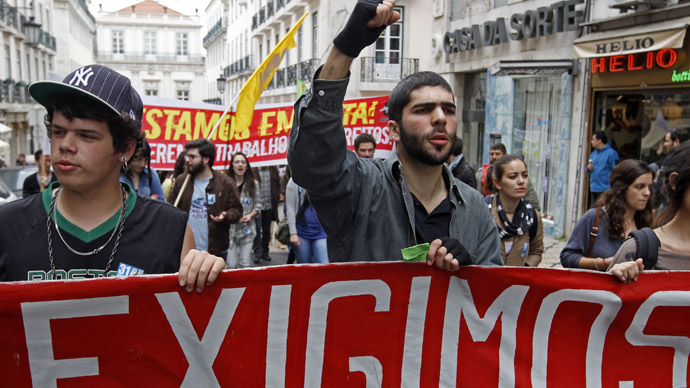 Youth march with a banner saying "We demand" during a protest against unemployment and government austerity measures in Lisbon