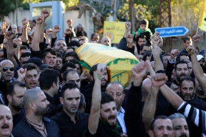 Mourners chant slogans as they carry the body of Adel Termos, who was killed in a twin bombing attack that rocked a busy shopping street in the area of Burj al-Barajneh in Beirut's southern suburb, during his funeral in the village of Tallussa in the Nabatiyeh governorate, south of Lebanon on November 13, 2015. Lebanon mourned 44 people killed in south Beirut in a twin bombing claimed by the Islamic State group, the bloodiest such attack in years, the Red Cross also said at least 239 people were also wounded, several in critical condition. AFP PHOTO / MAHMOUD ZAYYAT